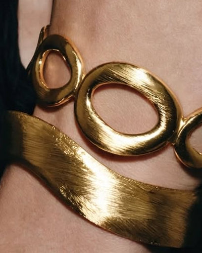Close-up of the Contour sculpted cuff in gold, worn