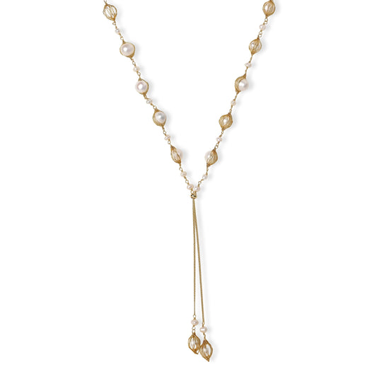 Adjustable gold lariat necklace with freshwater pearls nested in delicate cage settings and Y-shaped tassel drop