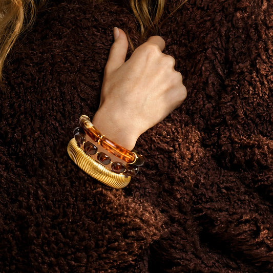 Ecaille Beaded Cuff in tortoiseshell and amber, worn stacked with the Audace Wide Cuff