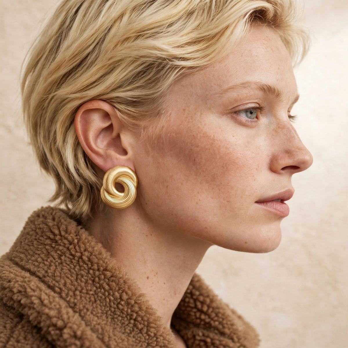 Infinity Twist Earrings in gold, a coiled sculptural stud