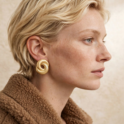 Infinity Twist Earrings in gold, a coiled sculptural stud