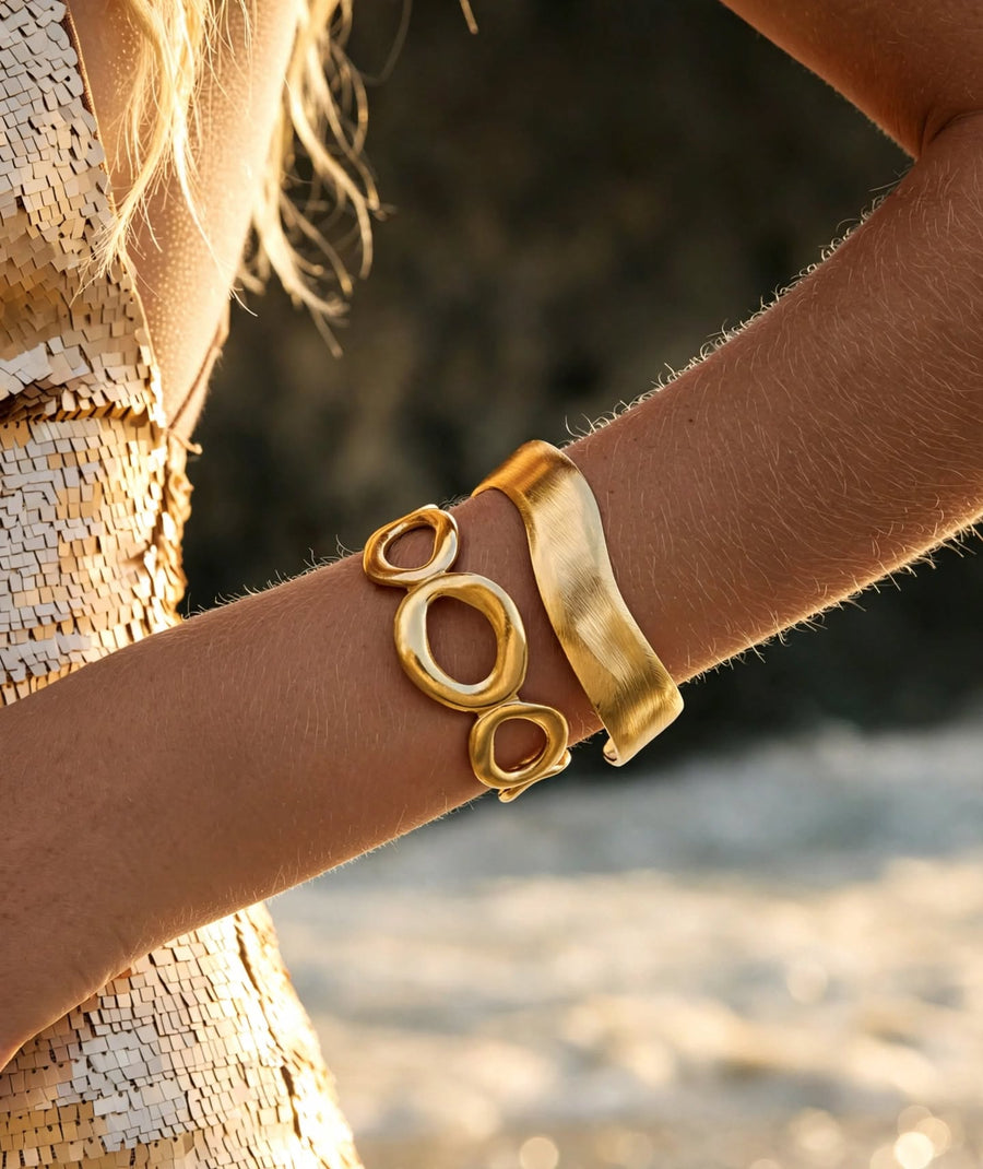 Orchidée earrings styled with two gold cuffs
